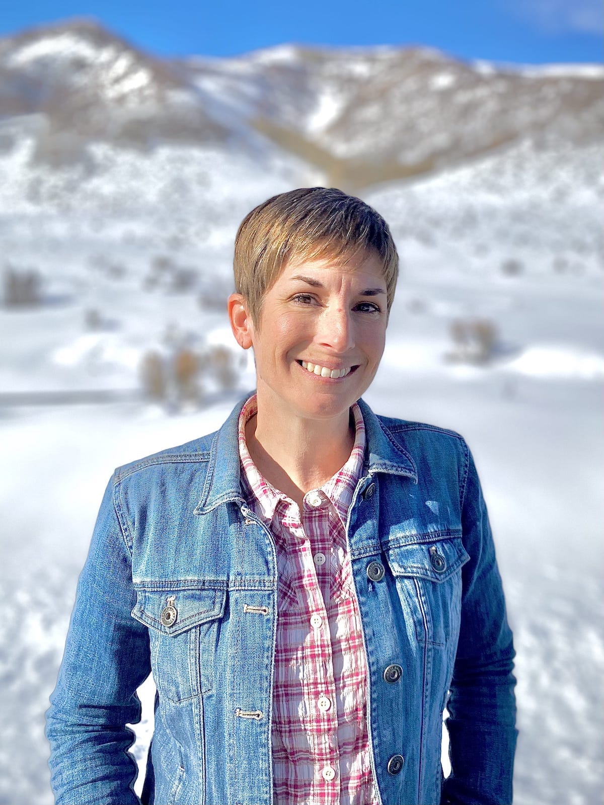 Melissa Dobbins outdoors with Colorado mountains in the background